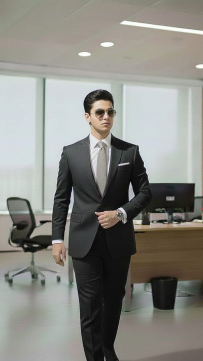 Boy wearing a black 2-piece formal suit for kids – coat and matching pants