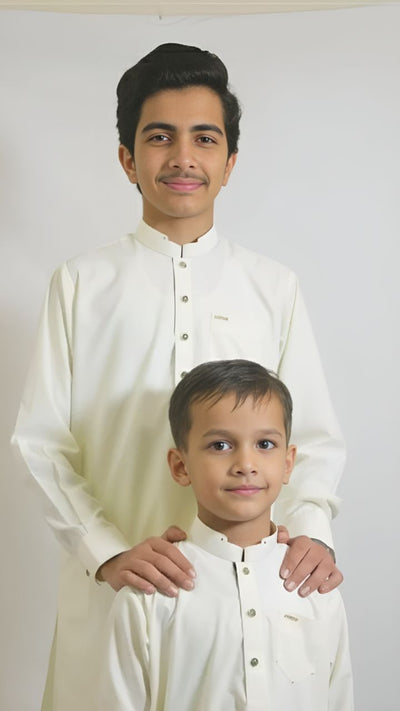 Cream White kids suit with blue-golden buttons, ban-shaped collar, and blue contrast back by Asjal Clothes Pakistan.
